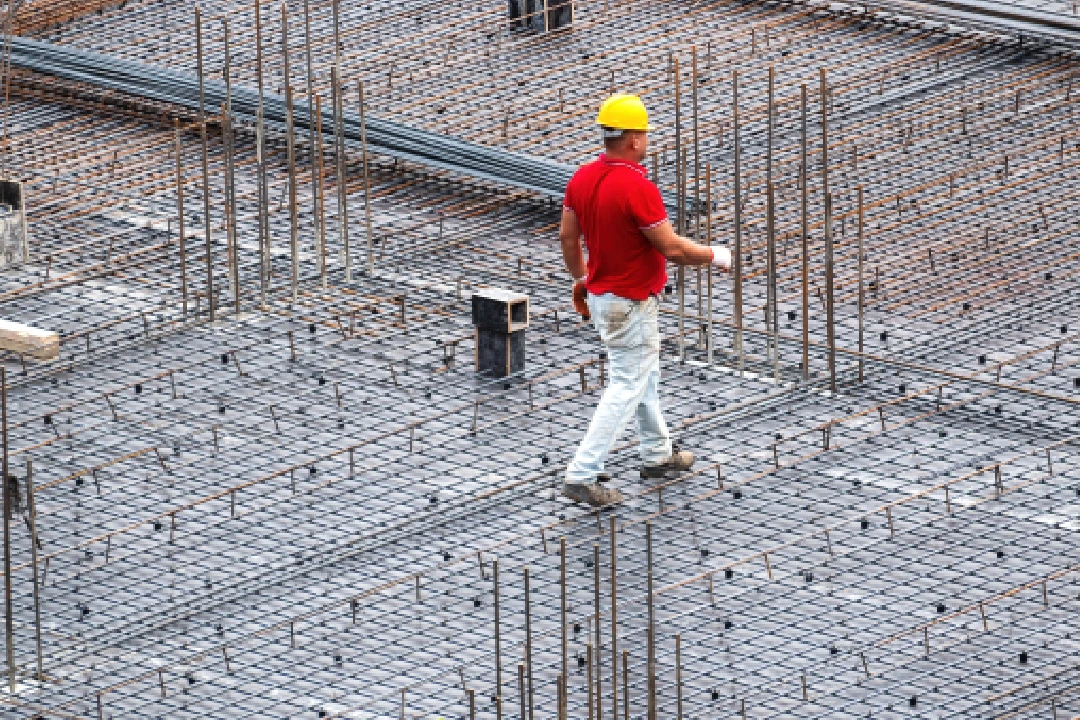 Man walking on a concrete slab rebars
